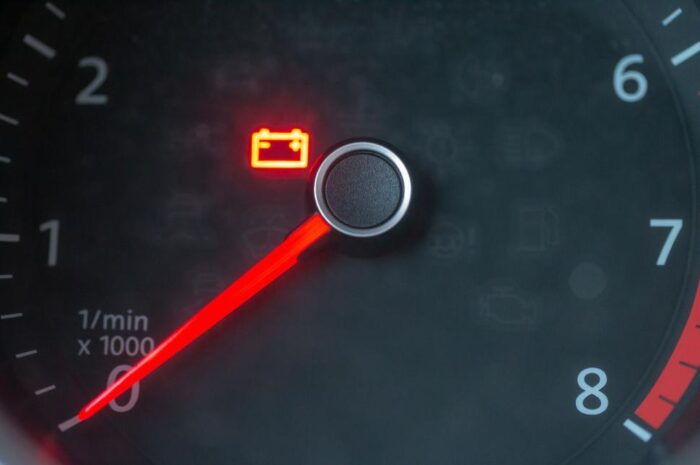 car-tachometer-showing-warning-light-on-a-black-dashboard
